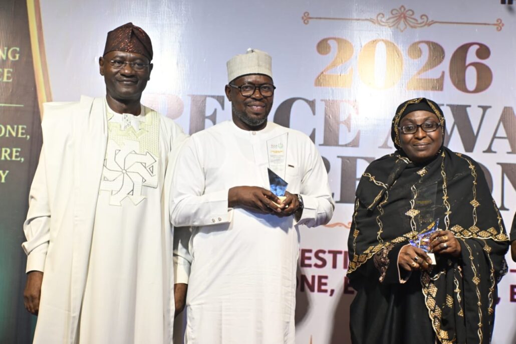 The Country Representative of FFA, Mr Felix Joseph Samari (middle) receiving the award